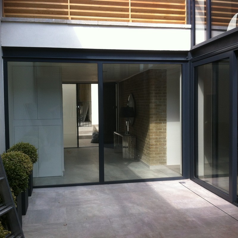 Floor-to-ceiling sliding doors opening to courtyard in Raynes Park
