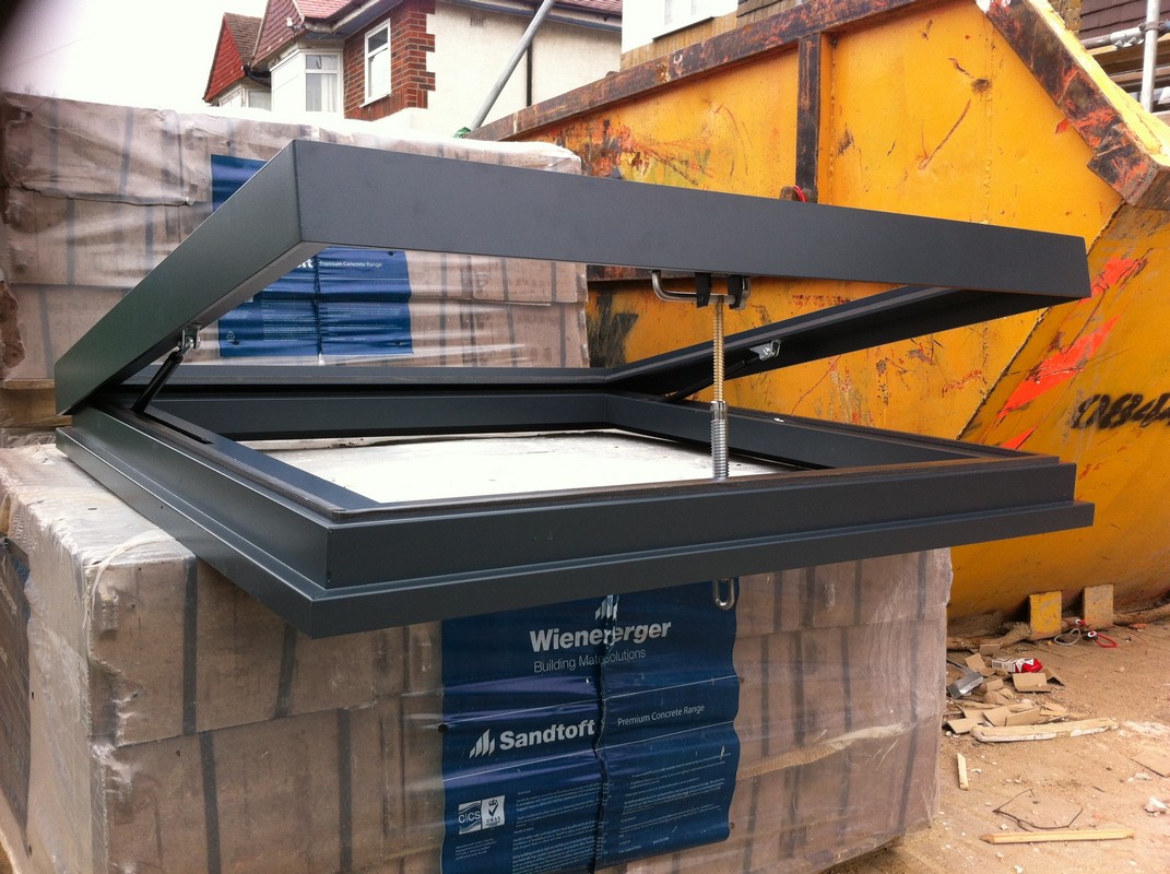 Opening flat roof skylight in anthracite grey installed in Raynes Park