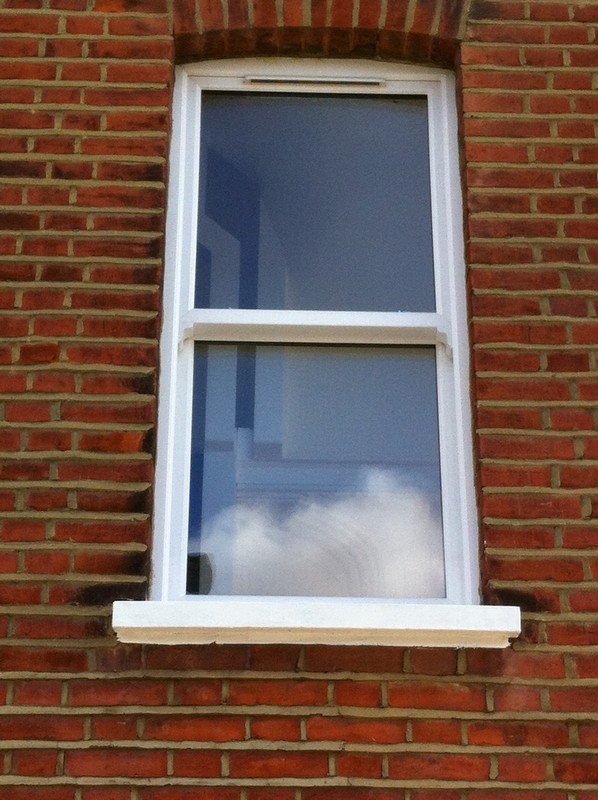 uPVC sash window on Victorian red brick house in Raynes Park